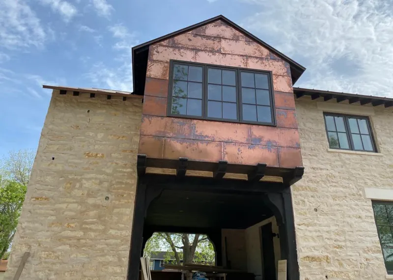 Copper metal panel facade on a stone building for Skylight Installation in Morehead