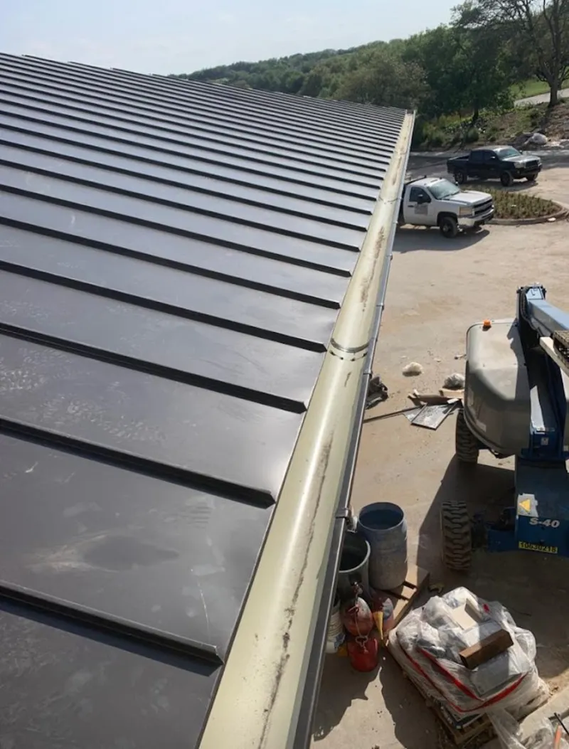Standing seam panel and gutter detail on a metal roofing jobsite in Morehead